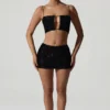 Ariana Oberteil mit Cut-outs und Verzierungen in Schwarz Ariana Oberteil mit Cut-outs und Verzierungen in Schwarz