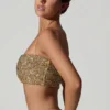 Ariana Verziertes Crop-Top mit Cut-outs in Gold Ariana Verziertes Crop-Top mit Cut-outs in Gold