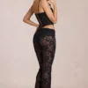 Calista Sheer Lace Mid-Rise Flared Trousers in Schwarz