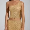 Cosette – Verziertes, asymmetrisches Oberteil mit Schaldetail in Gold Cosette – Verziertes, asymmetrisches Oberteil mit Schaldetail in Gold