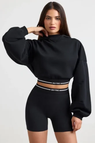 Cropped-Hoodie aus Stretch-Baumwollfleece in Schwarz