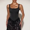 Eira Satin-Korsett-Minikleid mit verziertem Rock in Schwarz-Lila Eira Satin-Korsett-Minikleid mit verziertem Rock in Schwarz-Lila