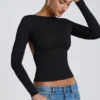 Elli Modal-Oberteil mit hohem Kragen, langen Ärmeln und offenem Rücken in Schwarz Elli Modal-Oberteil mit hohem Kragen, langen Ärmeln und offenem Rücken in Schwarz