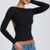 Elli Modal-Oberteil mit hohem Kragen, langen Ärmeln und offenem Rücken in Schwarz Elli Modal-Oberteil mit hohem Kragen, langen Ärmeln und offenem Rücken in Schwarz