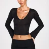 Liah Transparentes Jersey-Oberteil mit tiefem Ausschnitt und langen Ärmeln in Schwarz Liah Transparentes Jersey-Oberteil mit tiefem Ausschnitt und langen Ärmeln in Schwarz