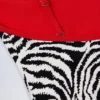 Ostend Badeanzug mit Kreuzrücken und Charm-Details im Zebradruck Ostend Badeanzug mit Kreuzrücken und Charm-Details im Zebradruck