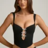Pearla Korsett-Oberteil mit Cut-outs und Schleifendetail in Schwarz Pearla Korsett-Oberteil mit Cut-outs und Schleifendetail in Schwarz