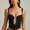 Pearla Korsett-Oberteil mit Cut-outs und Schleifendetail in Schwarz Pearla Korsett-Oberteil mit Cut-outs und Schleifendetail in Schwarz