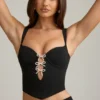 Pearla Korsett-Oberteil mit Cut-outs und Schleifendetail in Schwarz Pearla Korsett-Oberteil mit Cut-outs und Schleifendetail in Schwarz