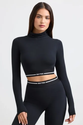 Rückenfreies, langärmeliges Crop-Top mit Rollkragen in Schwarz