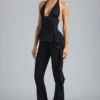 Reese Metallic-Rüschen-Hose mit niedriger Leibhöhe und ausgestelltem Bein in Schwarz Reese Metallic-Rüschen-Hose mit niedriger Leibhöhe und ausgestelltem Bein in Schwarz