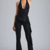 Reese Metallic-Rüschen-Hose mit niedriger Leibhöhe und ausgestelltem Bein in Schwarz Reese Metallic-Rüschen-Hose mit niedriger Leibhöhe und ausgestelltem Bein in Schwarz