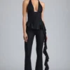 Reese Metallic-Rüschen-Hose mit niedriger Leibhöhe und ausgestelltem Bein in Schwarz Reese Metallic-Rüschen-Hose mit niedriger Leibhöhe und ausgestelltem Bein in Schwarz