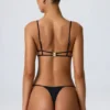 Sanibel Bikinioberteil mit Kettenverzierung und Cut-outs in Schwarz Sanibel Bikinioberteil mit Kettenverzierung und Cut-outs in Schwarz