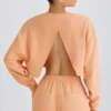 Strukturierter Baumwolljersey-Sweater mit offenem Rücken in Pfirsich Strukturierter Baumwolljersey-Sweater mit offenem Rücken in Pfirsich