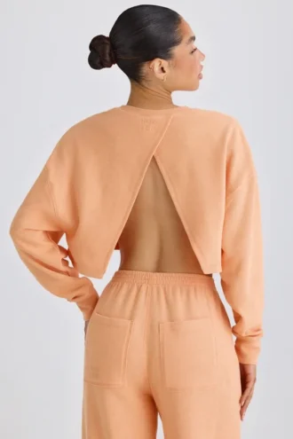 Strukturierter Baumwolljersey-Sweater mit offenem Rücken in Pfirsich
