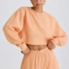 Strukturierter Baumwolljersey-Sweater mit offenem Rücken in Pfirsich Strukturierter Baumwolljersey-Sweater mit offenem Rücken in Pfirsich