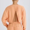 Strukturierter Baumwolljersey-Sweater mit offenem Rücken in Pfirsich Strukturierter Baumwolljersey-Sweater mit offenem Rücken in Pfirsich