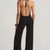 Tulay Devoré-Jumpsuit mit Neckholder und offenem Rücken in Schwarz Tulay Devoré-Jumpsuit mit Neckholder und offenem Rücken in Schwarz